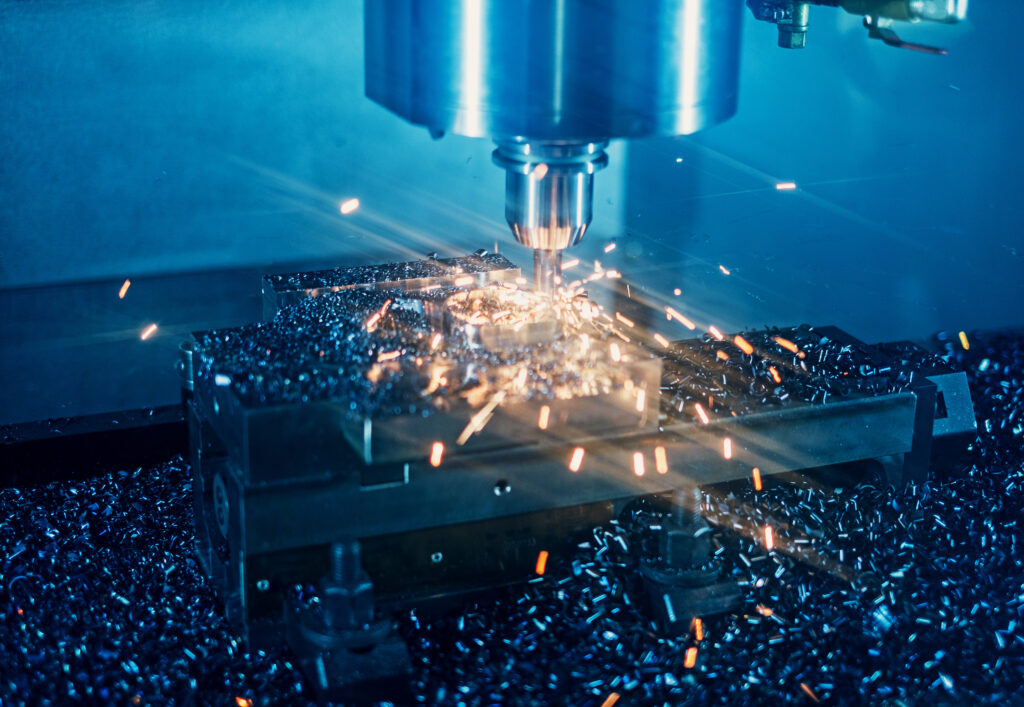 Milling machine working on steel detail with lot of sparks.